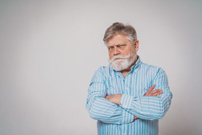 Portrait of man standing against white background