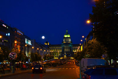 Illuminated city street at night