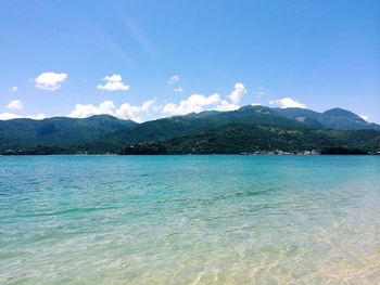 Scenic view of lake and mountains against sky