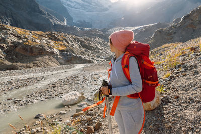 Rear view of woman standing on mountain