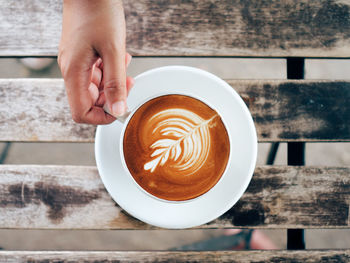 Midsection of coffee cup on table