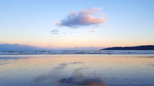 Scenic view of beach against sky during sunset