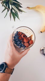 High angle view of hand holding ice cream in bowl