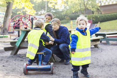 Kindergarten teacher with children on playground