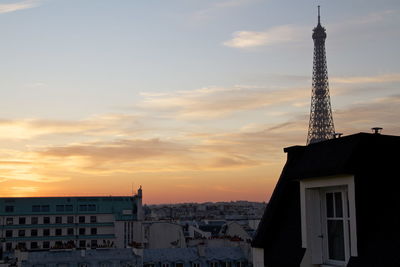 Eiffel tower against sky during sunset in city