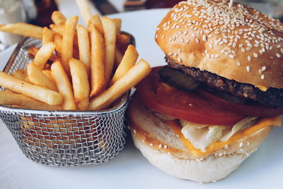 Close-up of burger and french fries served in plate