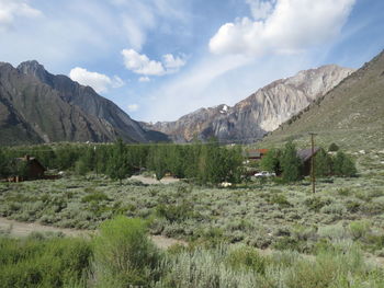 Scenic view of land and mountains against sky