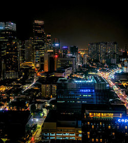 Illuminated cityscape against sky at night