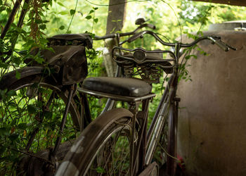 2 old bicycles parked in the garage.