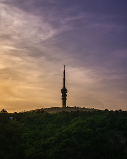 Silhouette of building against cloudy sky