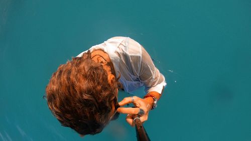 High angle view of woman holding blue water