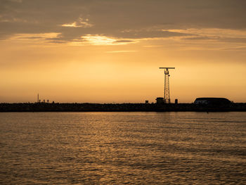 Scenic view of sea against orange sky