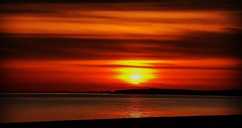 Scenic view of sea against orange sky