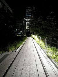 Road passing through city at night