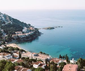 High angle view of cityscape by sea against sky