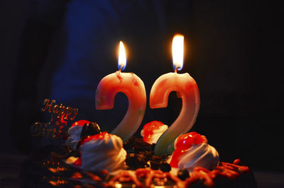 Close-up of burning candles on birthday cake