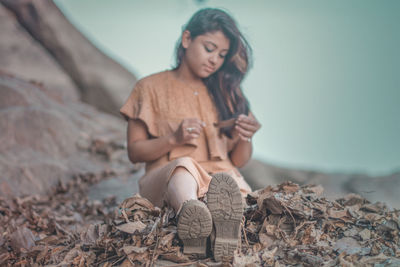 Close-up of young woman sitting outdoors