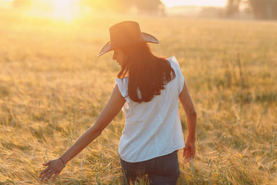 Side view of woman standing on field