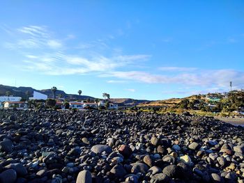 Scenic view of beach against blue sky