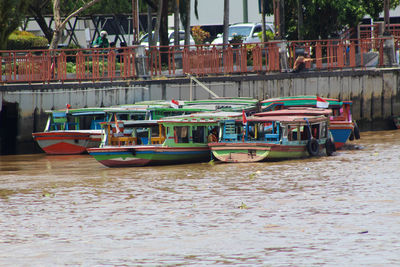 Boats moored at harbor