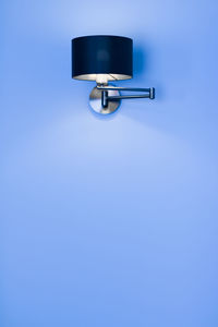 Close-up of electric lamp against blue background