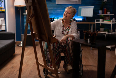 Portrait of young woman sitting on chair