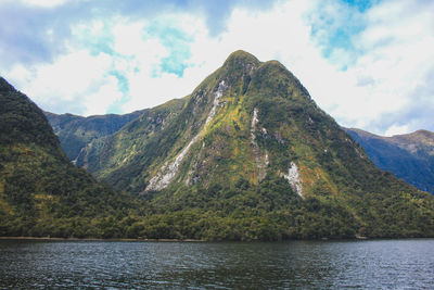 Scenic view of lake and mountains against sky