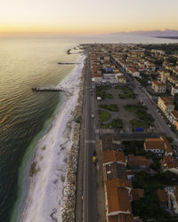 High angle view of city by sea against sky