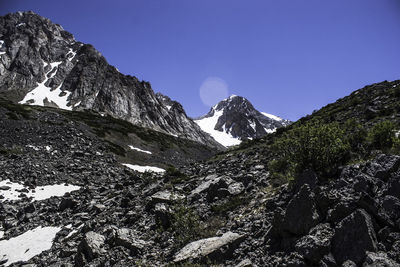 Scenic view of snowcapped mountains against clear blue sky