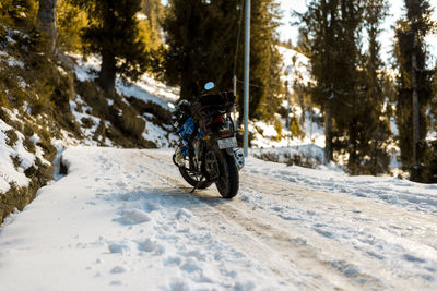 Man cycling on snow covered road