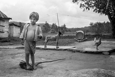 Boy playing on field against sky