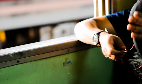 Cropped hand of person wearing watch