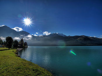 Scenic view of lake and mountains against sky