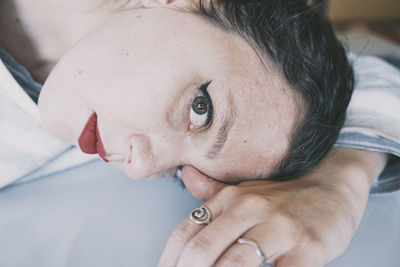 Close-up portrait of woman lying down