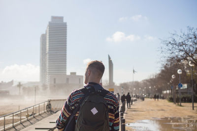 Man standing against sky in city