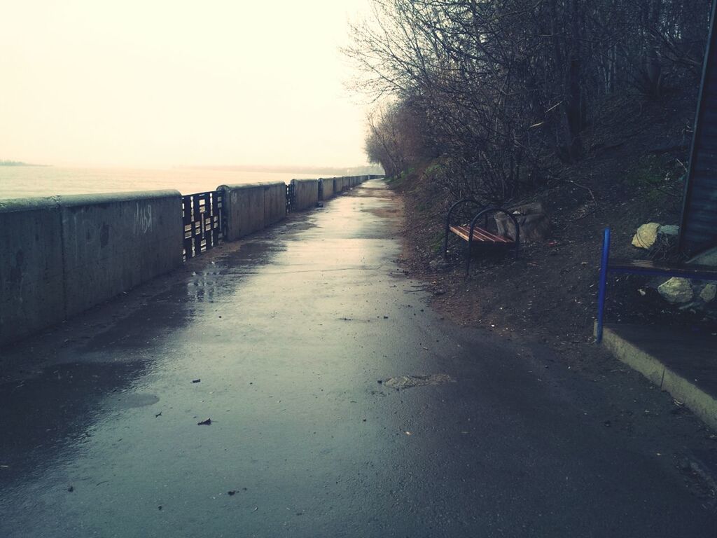 the way forward, tranquility, railing, diminishing perspective, tranquil scene, nature, clear sky, empty, tree, no people, built structure, outdoors, sunlight, day, water, long, fence, absence, walkway, footpath