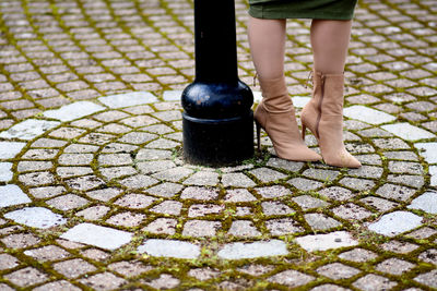 Low section of man standing on footpath