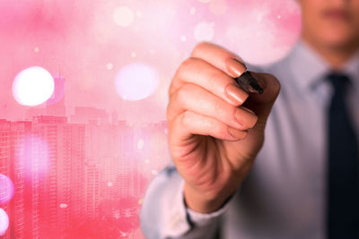 Close-up of man holding mobile phone