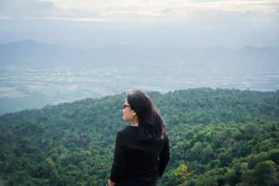 Rear view of man looking at mountain landscape