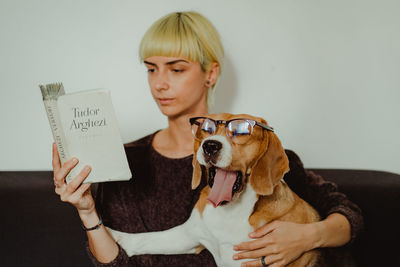 Portrait of teenage girl holding dog