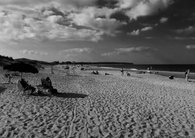 People on beach against sky