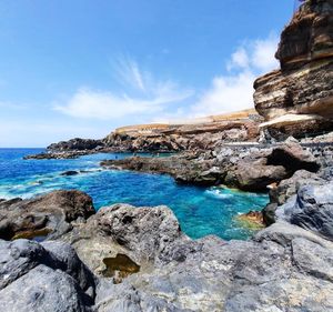 Scenic view of rocks by atlantic ocean - tenerife island, spain