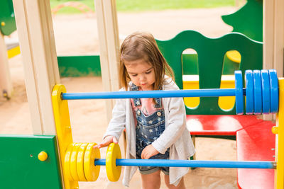 Low angle view of girl playing in playground