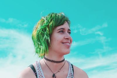 Close-up of beautiful woman against sky