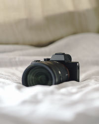 Close-up of camera on bed