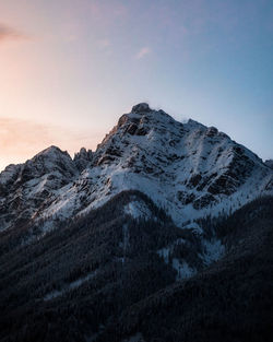 Scenic view of snowcapped mountains against sky during sunset