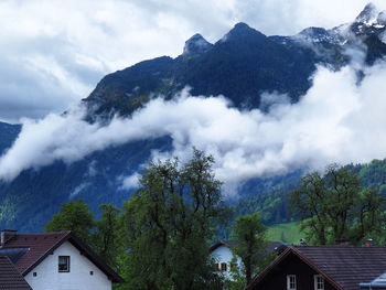 Scenic view of mountains and buildings against sky