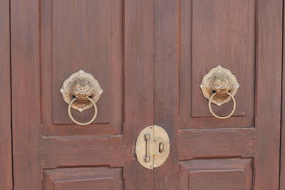 Full frame shot of old door with knockers