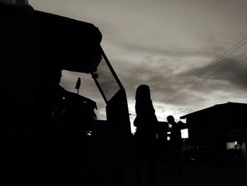 High section of silhouette built structures against sky