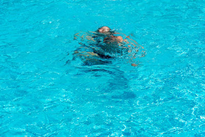 High angle view of man swimming in pool